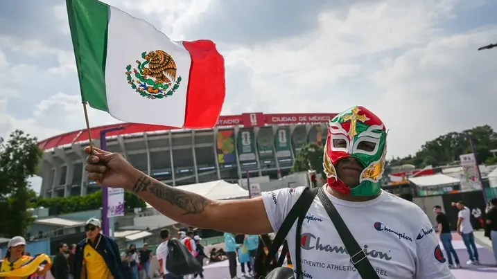 Pendukung Tim Nasional Meksiko bertopeng mengibarkan bendera negaranya di kawasan Stadion Azteca, Mexico City, Meksiko, Rabu (10/6/2026). (Foto: Antara) Suporter Meksiko - Pildun